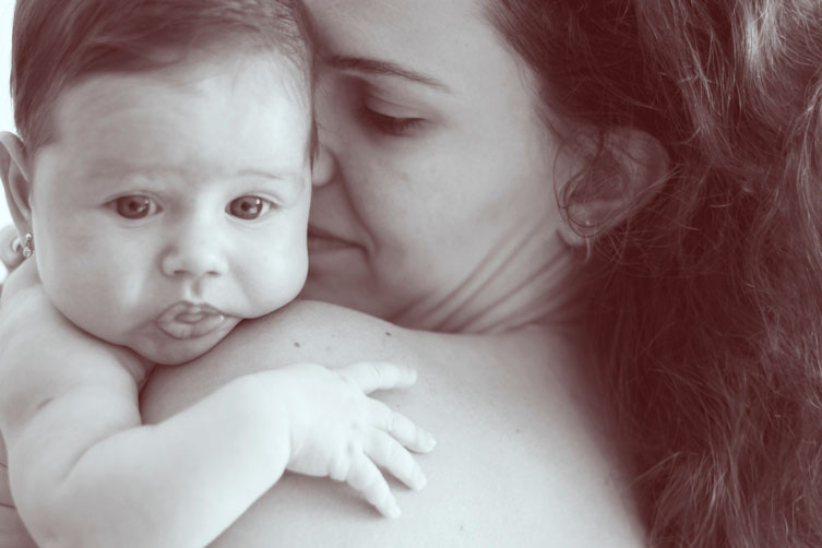 Mother Holding Baby In Upright Position